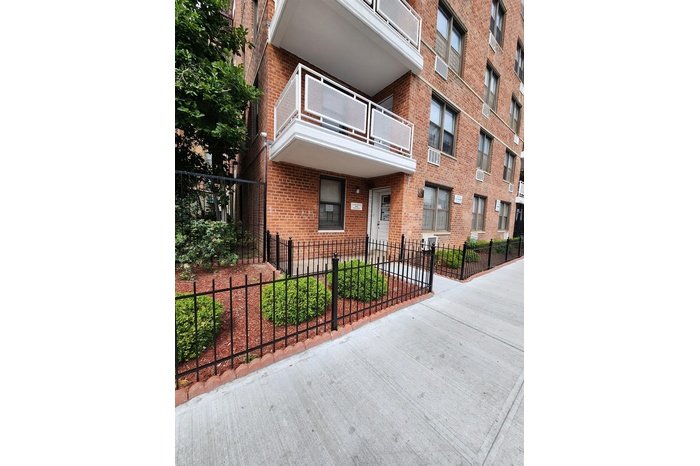View of building exterior featuring a fenced front yard