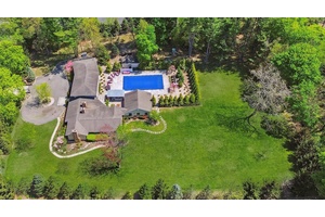 Tucked away on a fully fenced, over two acre, park like, electronic gated property, stands a sprawling Farm Rach expanded and remodeled in 2007.