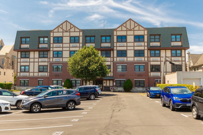 View of property featuring uncovered parking