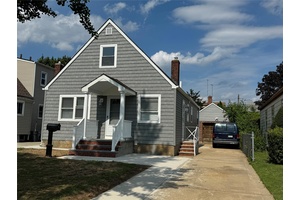 This beautifully renovated Cape style home features three spacious bedrooms and gleaming hardwood floors throughout.