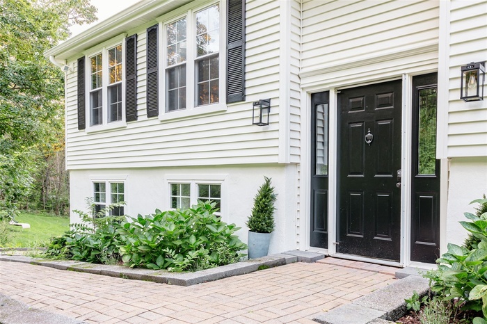 Entrance to property with stucco siding