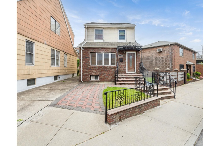 View of front facade with brick siding and entry steps