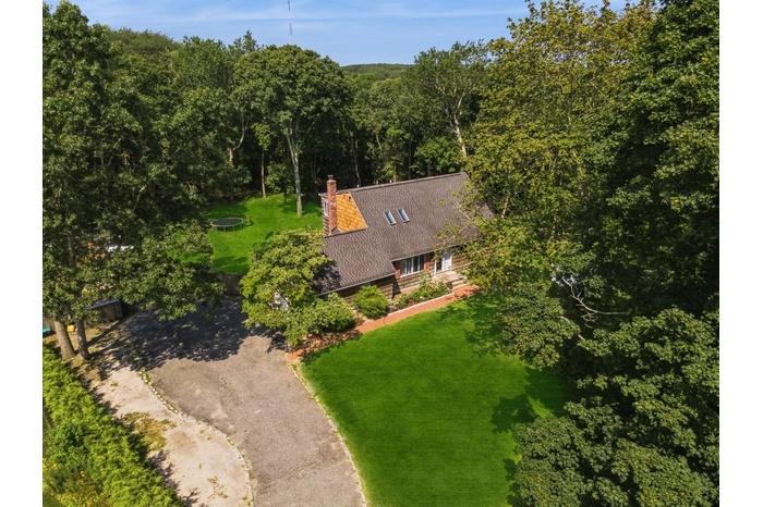 View from above of property featuring a forest