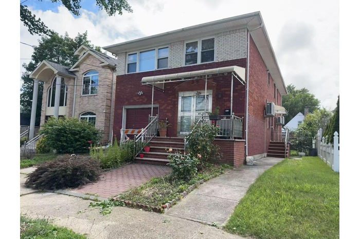 View of front of house featuring brick siding and a porch