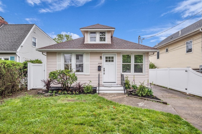 Bungalow-style house with a shingled roof