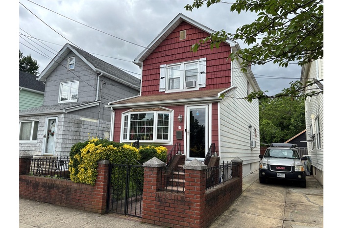 View of front facade with a fenced front yard and a gate