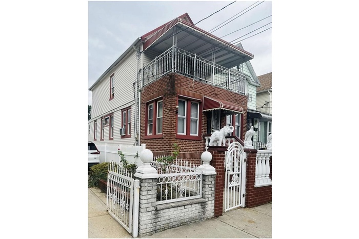 Multi unit property featuring brick siding, a balcony, and cooling unit