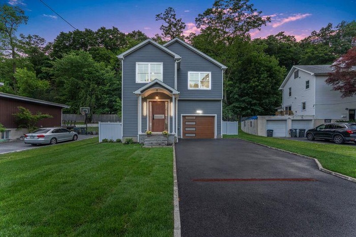 Traditional home with asphalt driveway and an attached garage