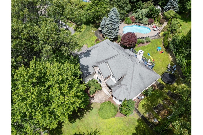 Aerial view of property and surrounding area with a pool