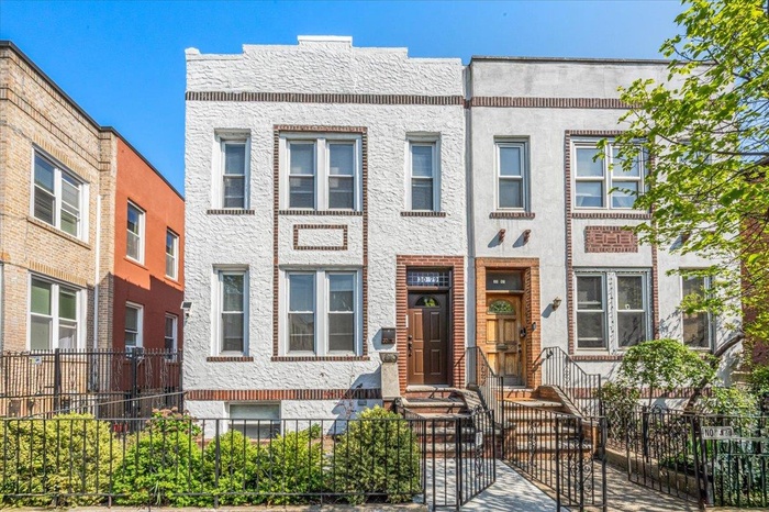 Multi unit property with stucco siding and a fenced front yard