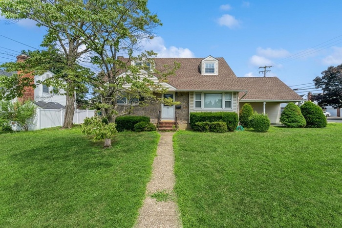 Cape cod-style house featuring a shingled roof