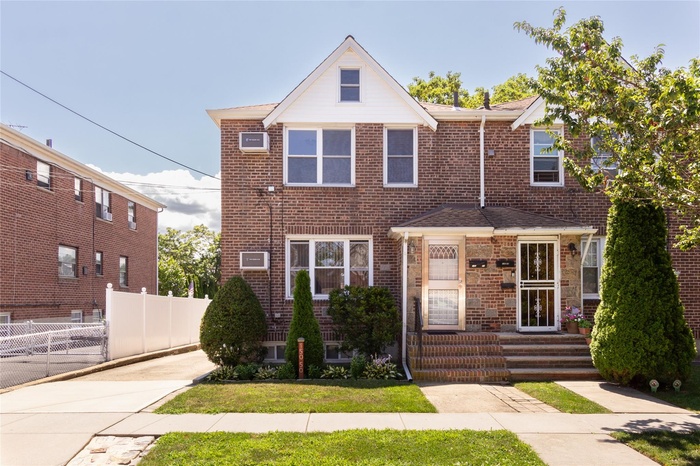 Traditional-style home featuring brick siding