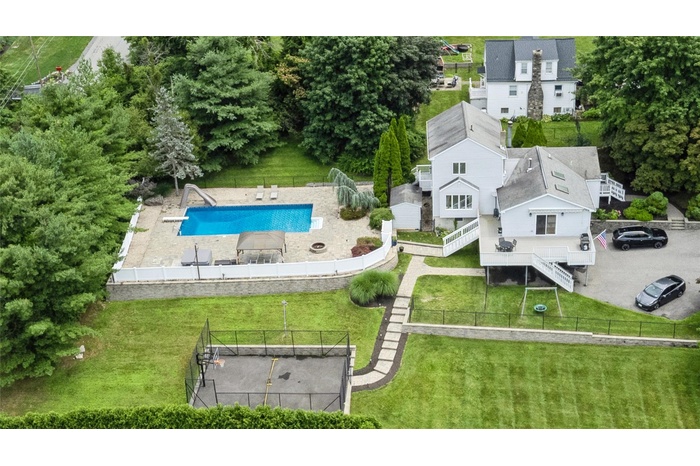 Aerial view of property and surrounding area with a pool area