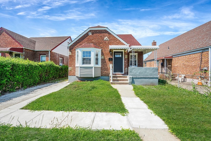 View of front of house featuring brick siding