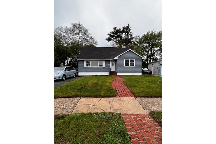 View of front of house featuring a front lawn and entry steps.