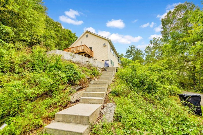 View of side of property with stairway