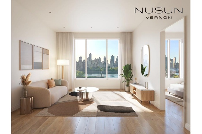 Living room featuring a view of skyline, light wood-style flooring, and baseboards