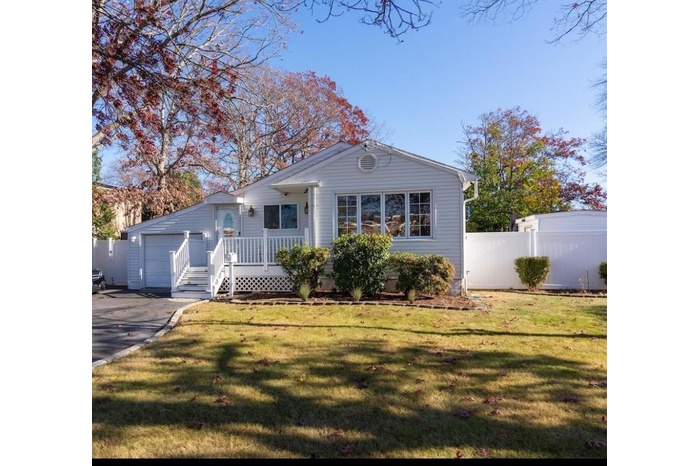 house with a front lawn, fence, aphalt driveway, and a garage