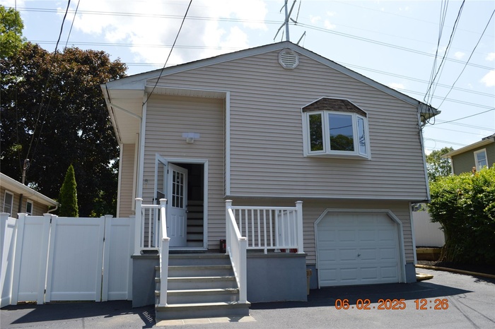 View of front of house featuring a garage and driveway