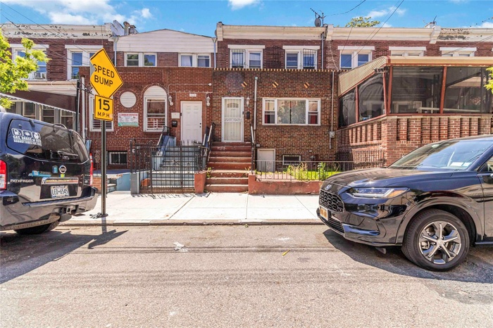 Townhome / multi-family property with brick siding and entry steps