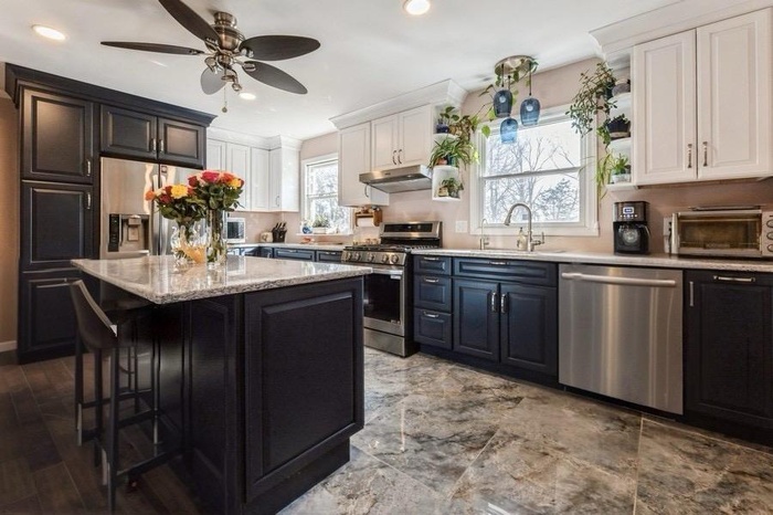 Kitchen featuring white cabinets, a toaster, stainless steel appliances, a ceiling fan, and a sink
