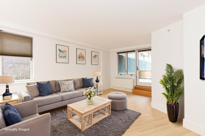 Living room with baseboards and light wood finished floors