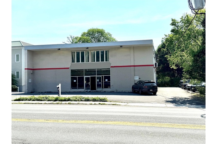 View of building exterior with parking