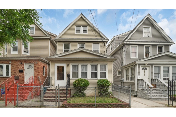 Traditional style home featuring entry steps, a gate, and a fenced front yard