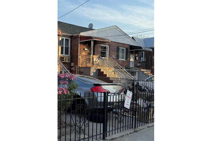 Ranch-style house with brick siding and a fenced front yard