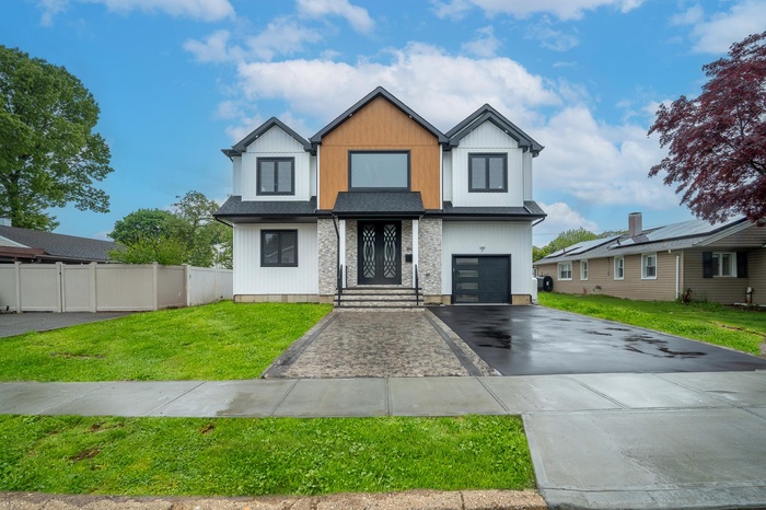 Modern home with asphalt driveway and an attached garage