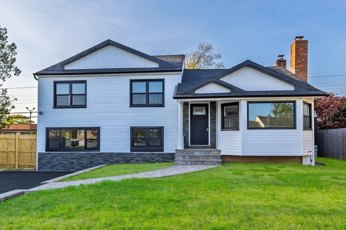View of front of house featuring board and batten siding and entry steps
