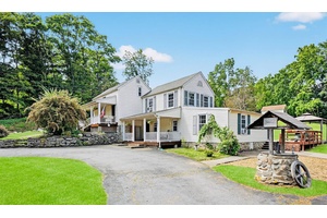 Welcome home to this storybook setting, where a majestic weeping cherry blossom greets you with it's graceful cascade of blossoms each spring.