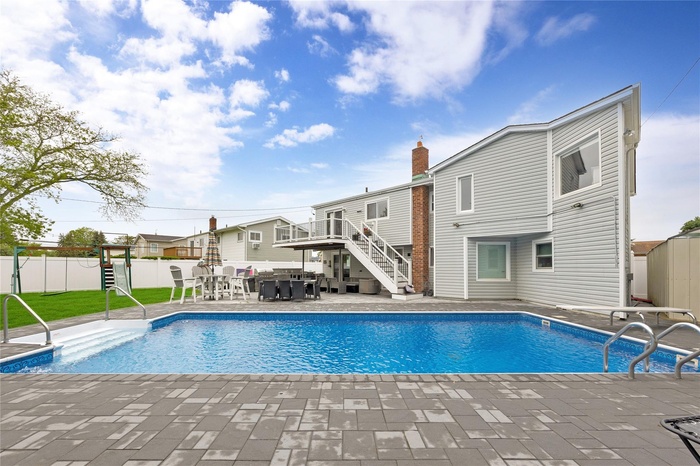 View of pool featuring stairway and a patio