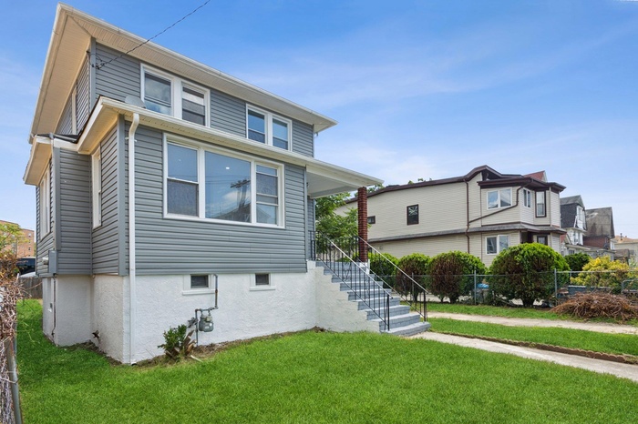 View of front of house featuring stairway and stucco siding