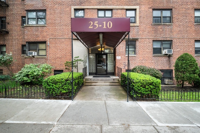 Entrance to property with brick siding and cooling unit