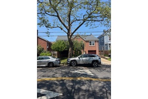 Brick detached house in Pelham garden section of The Bronx.