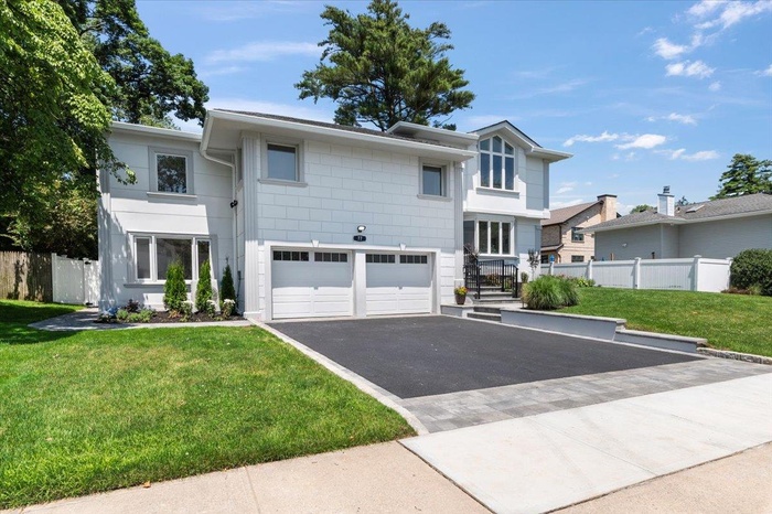 Modern home with asphalt driveway and a garage