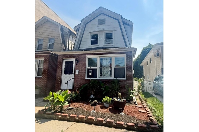 Dutch colonial with a gambrel roof and brick siding