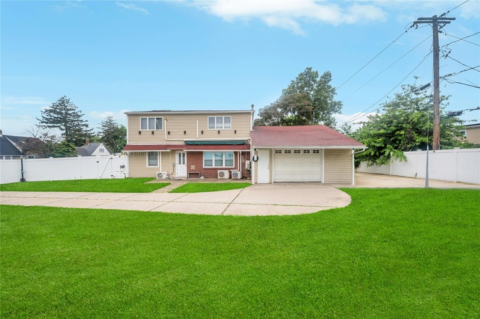 Traditional home with driveway and a garage