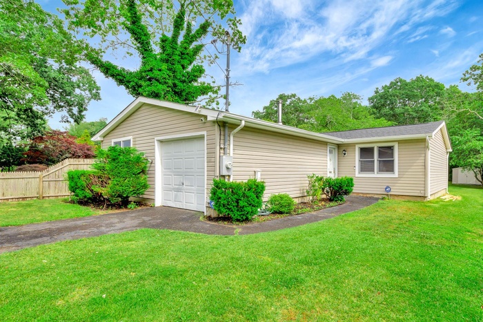View of front of property with driveway and a garage