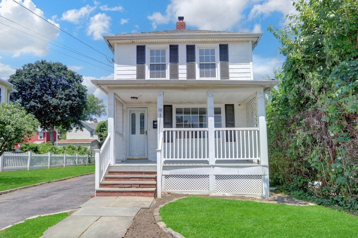 Traditional style home with a porch and a chimney