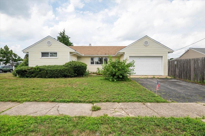Single story home with asphalt driveway and a garage