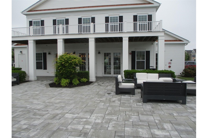 Back of house featuring an outdoor living space, a balcony, a patio, and french doors