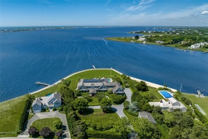 Introducing The Point, an exquisite waterfront estate situated on 2 acres with 380' of frontage on Moriches Bay, a private dock and separate carriage house.