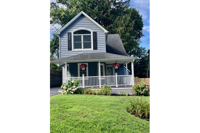 Cape Style with a porch, roof with shingles, and asphalt driveway