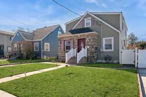 This Beautiful home that offers both comfort and functionality of a front door, back sliding door, side door and a basement outside entrance.