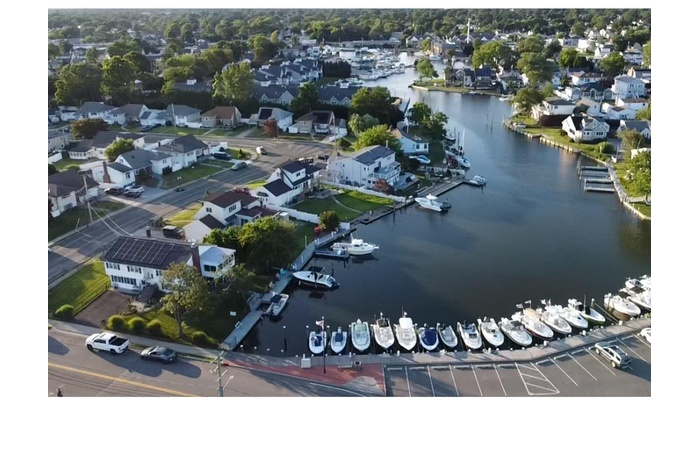 Aerial perspective of suburban area featuring a large body of water
