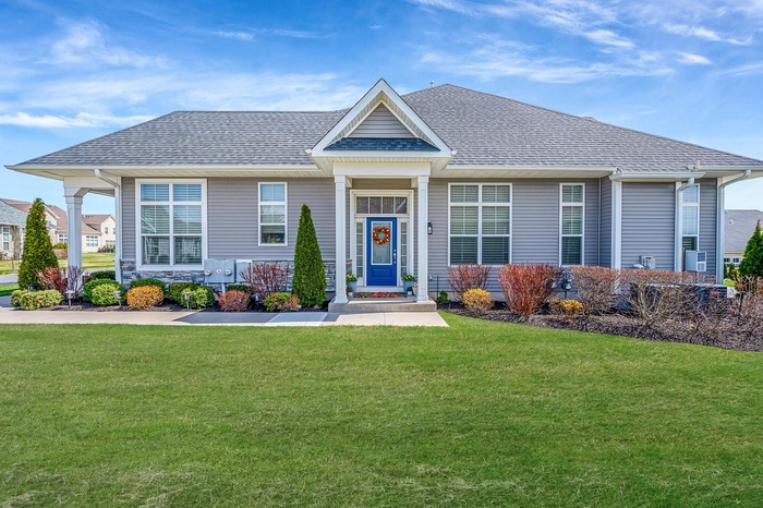 Craftsman inspired home featuring a front lawn and roof with shingles