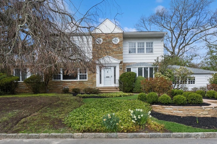 View of front of home with entry steps and stone siding