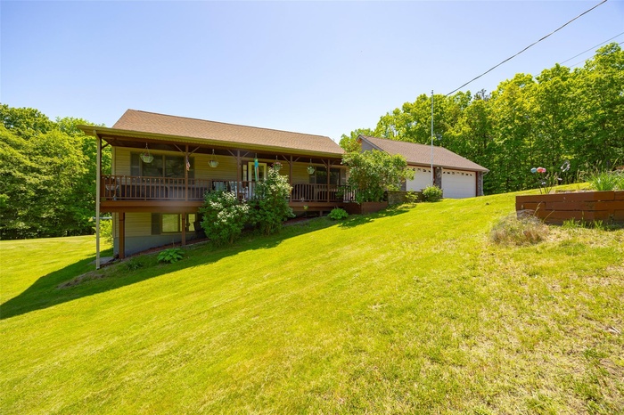 View of grassy yard with a garage